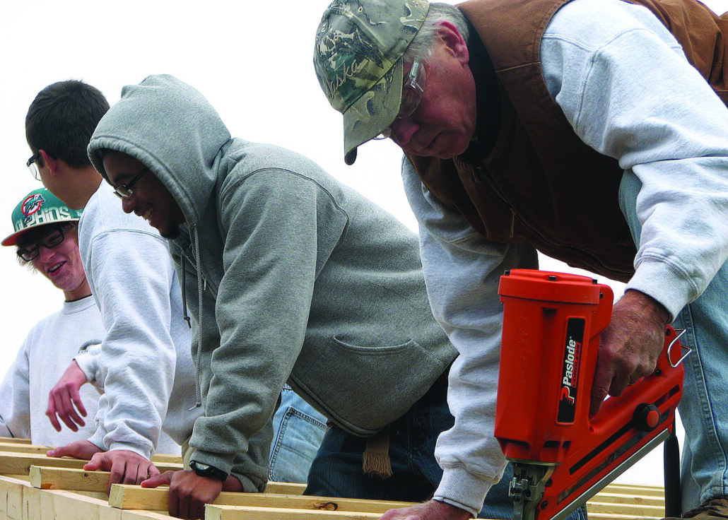 Adult and high school students from carpentry work side-by-side to complete SUN Tech's pavilion.