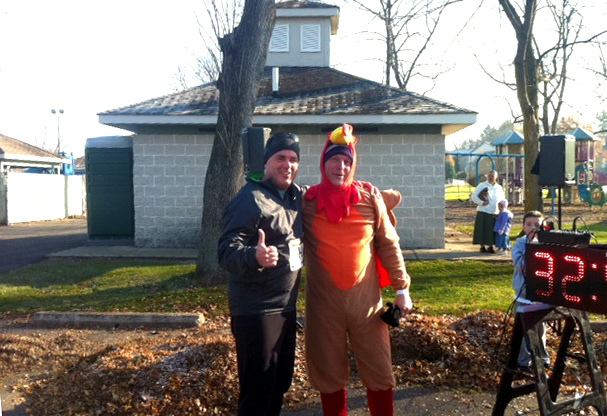 Co-Op Coordinator Joe Weisser poses with turkey trotter Drew Kelly of 94.1 WQKX