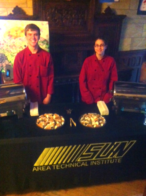 Cole and Amanda serve meatballs to attendees of the School Art Open House.
