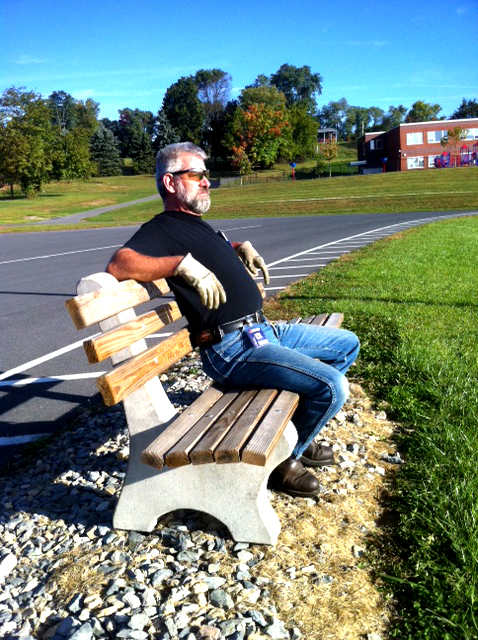 Mr. Styers takes a moment to enjoy the bench after delivery